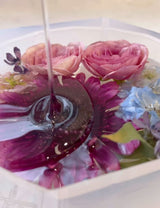 Pouring resin onto flowers to be preserved using a mold from Modern Mold.