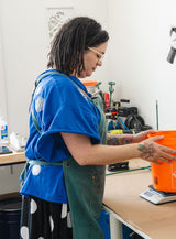 Melissa, founder of Modern Mold, weighing material in her workshop.